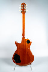 Knaggs Kenai guitar back on a stand against a white background