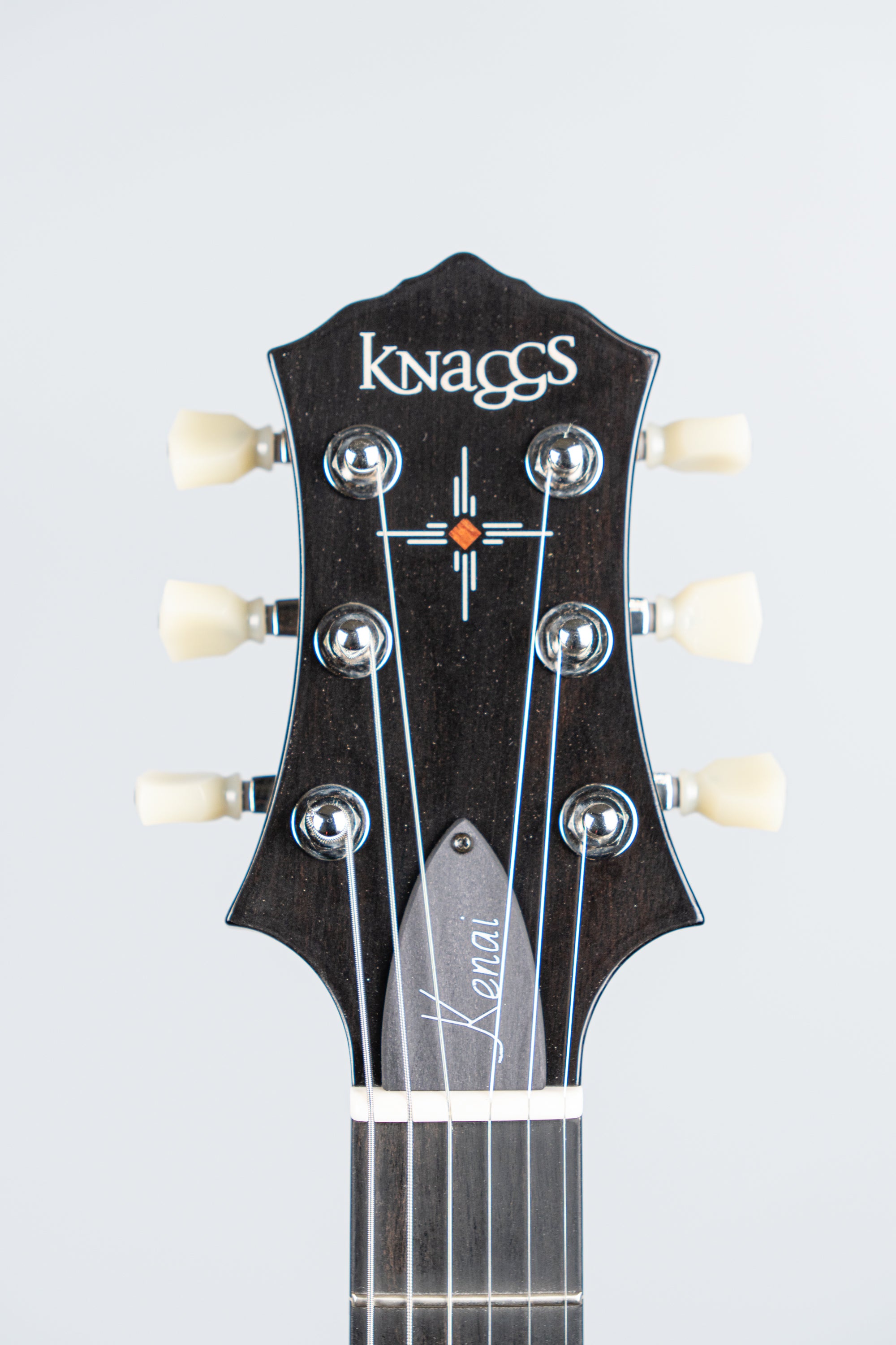 Knaggs Kenai electric Guitar headstock with 'Knaggs' branding on a light gray background
