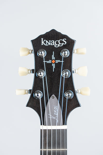 Knaggs Kenai electric Guitar headstock with 'Knaggs' branding on a light gray background