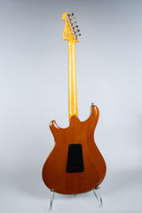 Electric guitar Knaggs Severn HSS back on a stand against a gray background