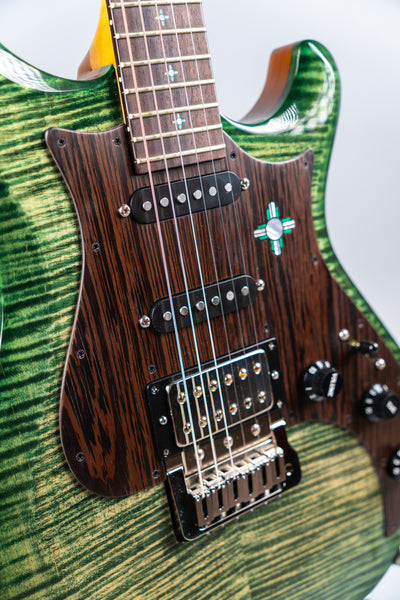 Close-up of an electric guitar Knaggs Severn HSS in color Jade Green with a brown wenge pickguard with a white background