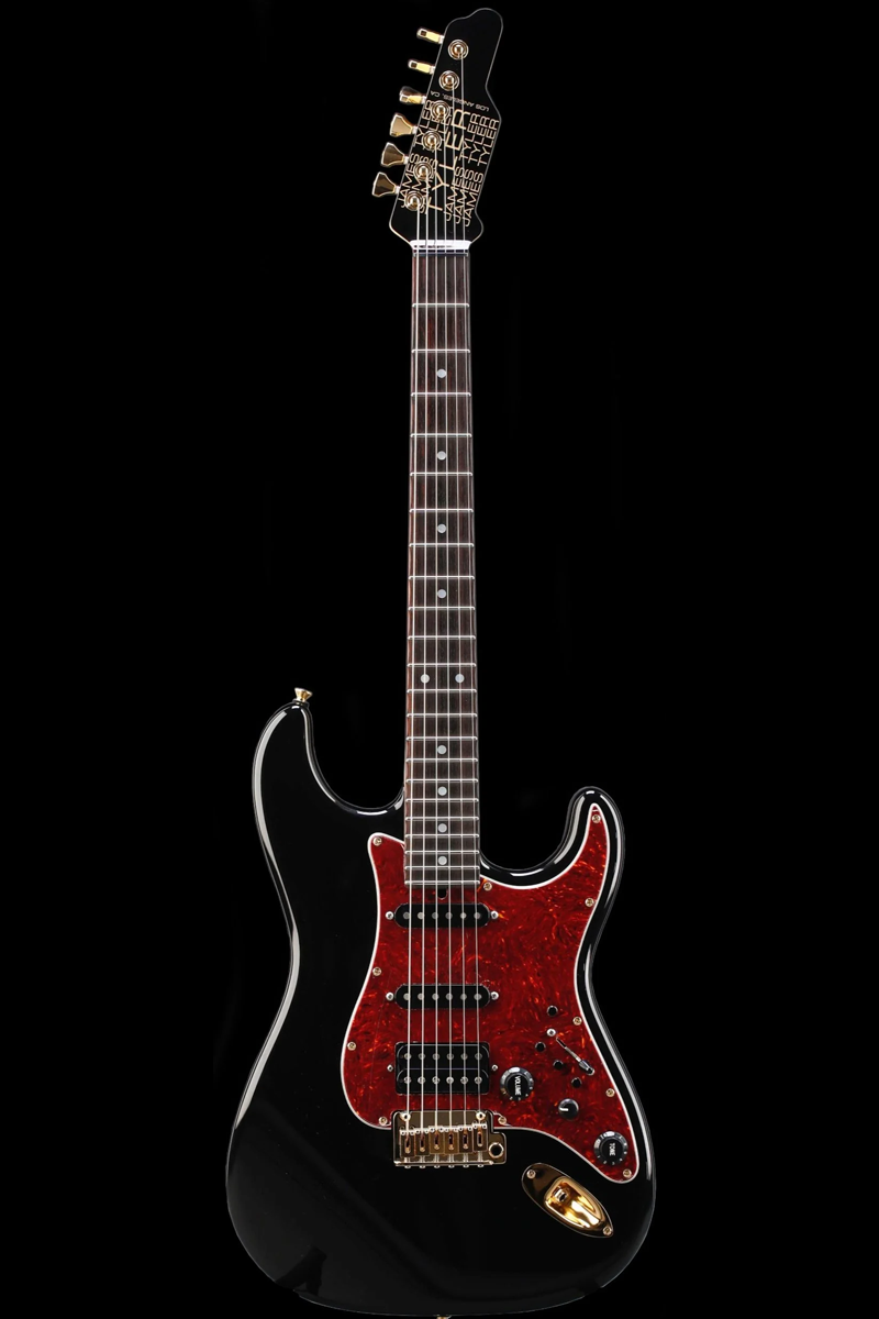 James Tyler Classic Dann Huff electric guitars with a black body, tortoise pickguard on a black background